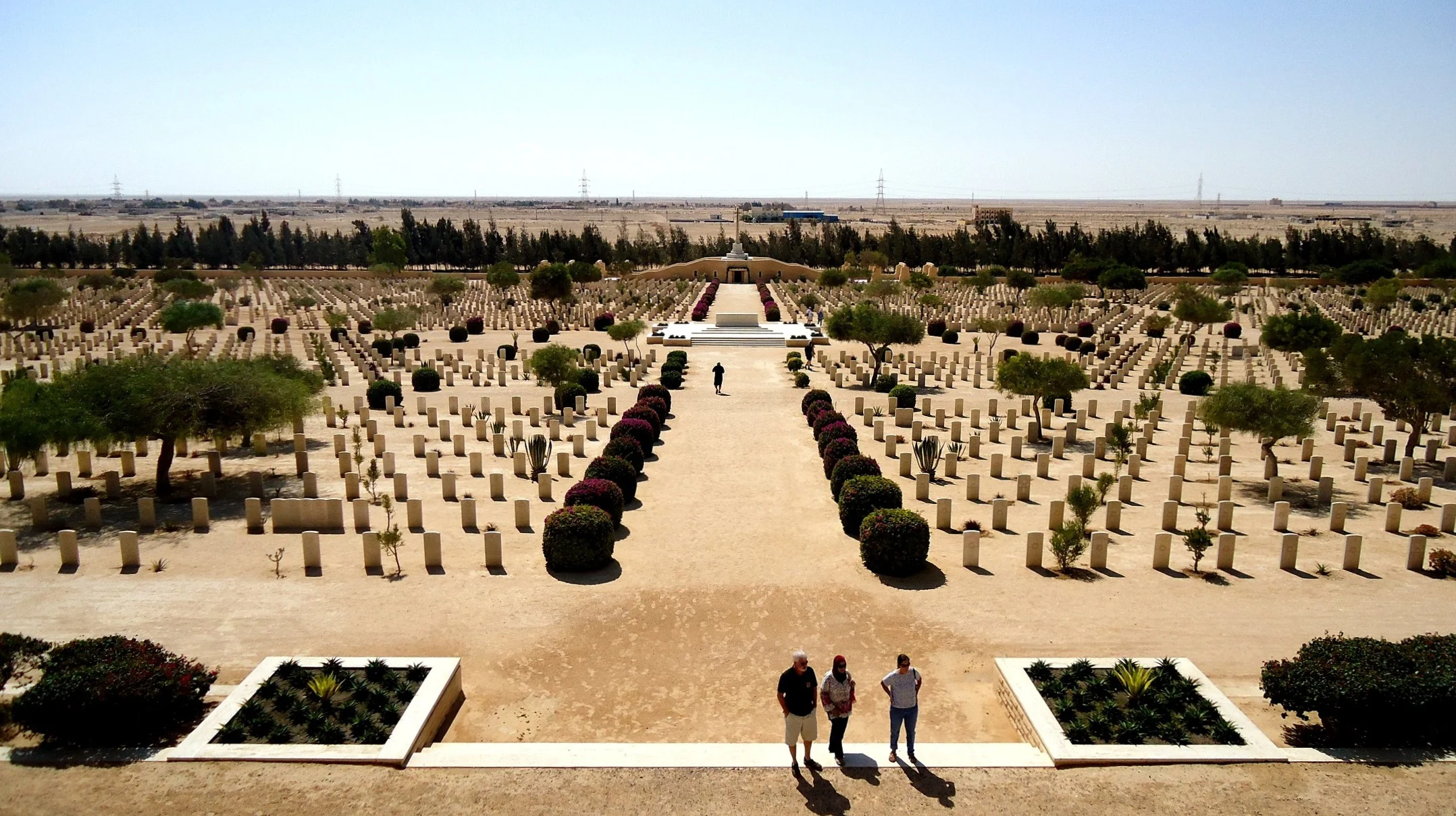 El Alamein Commonwealth War Cemetery panoramic view with rows of white headstones and the Alamein Memorial arch